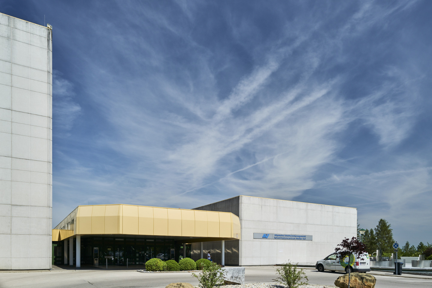 Vorderansicht des Rehabilitationszentrums Weißer Hof mit sichtbarem Eingang und Einfahrt. 